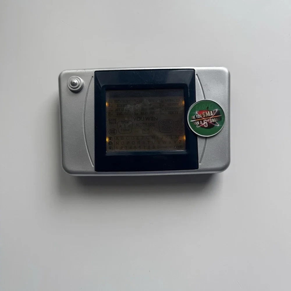 2007 Are You Smarter Than a 5th Grader Illuminated Electronic Handheld LCD Game